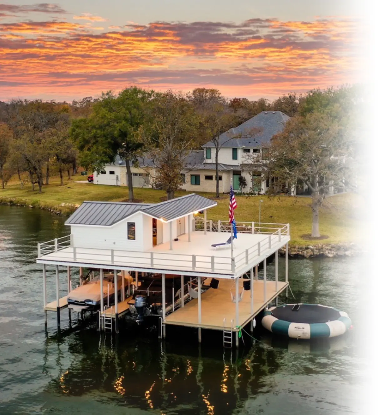 Modern white lake dock with covered boat slip and sunset view in Austin, Texas by Longhorn Docks